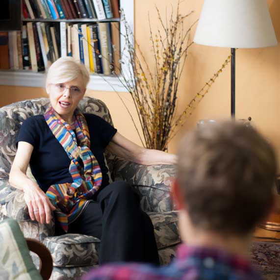 Therapist speaking with client in an office setting during a counseling session