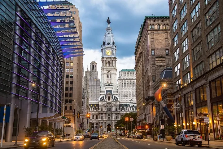 City Hall tower and Philadelphia street view at twilight with traffic