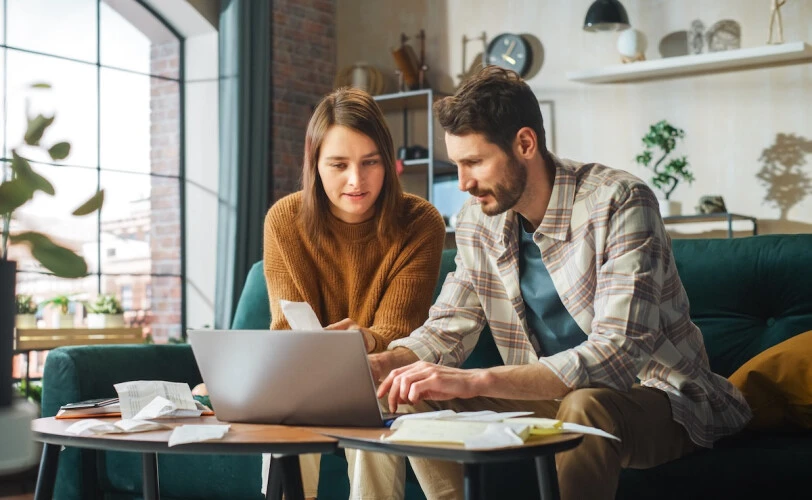 Couple reviewing finances together during a financial consultation at home