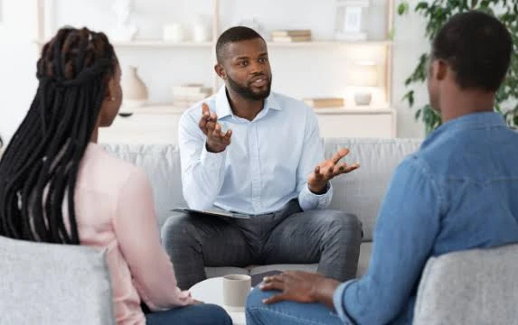 Counselor speaking with couple during a therapy session